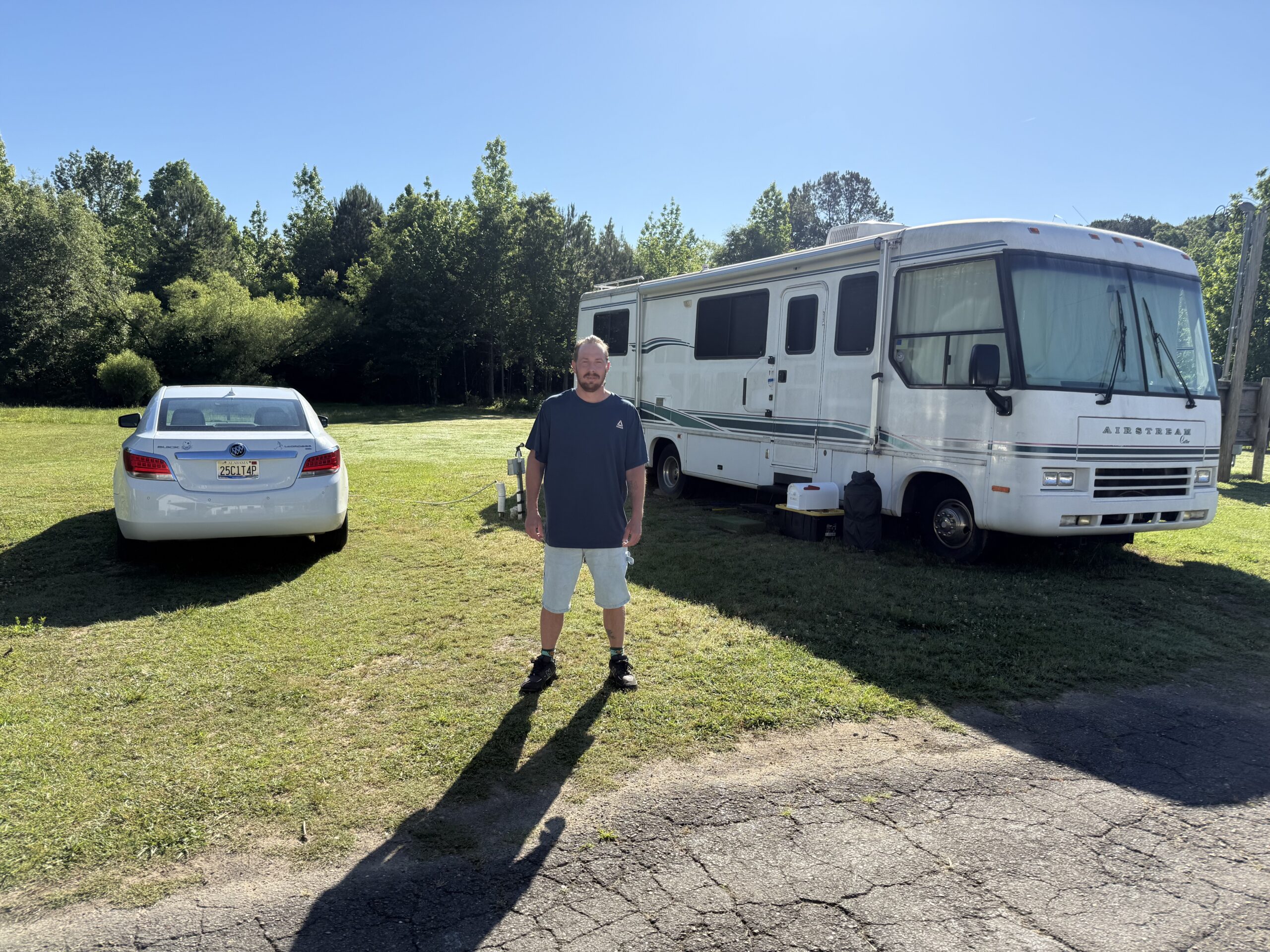 A CREAA resident standing beside his vehicles